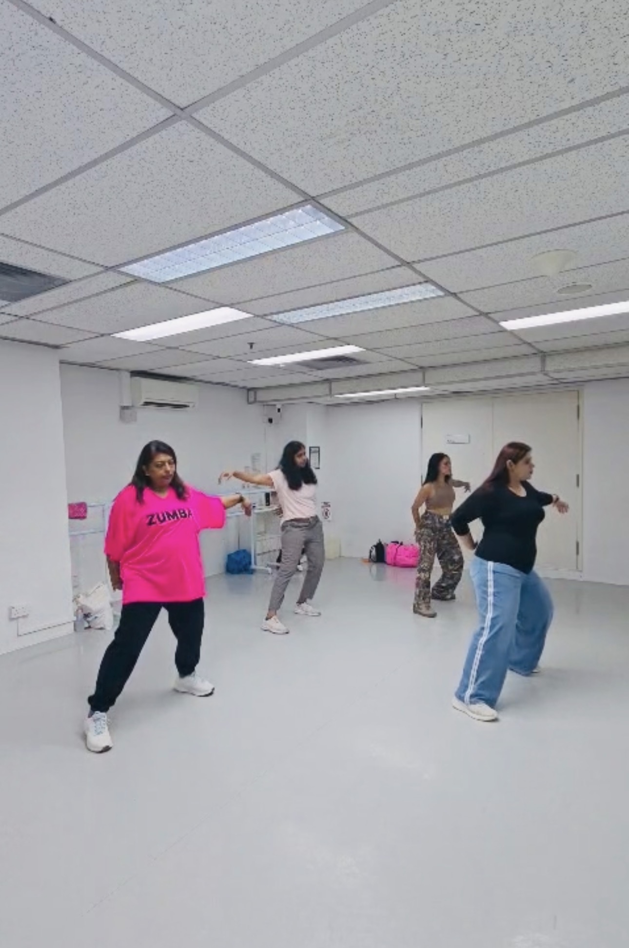 Swati and participants practising a dance sequence together
